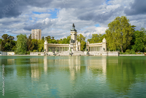Monument to King Alfonso XII in the pond of the Retiro park in the city of Madrid, during a sunny spring day with blue sky