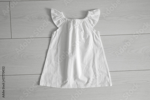 Mockup of white baby cotton dress on white background. Layout mock up ready for your design preview.