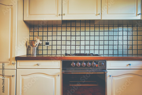 Vintage retro kitchen with green pattern tiles, american retro kitchen home interior design 70's 80's style close-up. retro