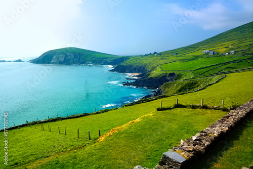 Cliffs and green fields of the scenic coast of the Dingle peninsula, County Kerry, Ireland