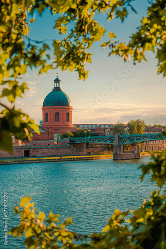 Toulouse, France. Beautiful cityscape with The River Garonne and La Grave dome in the background at sunset