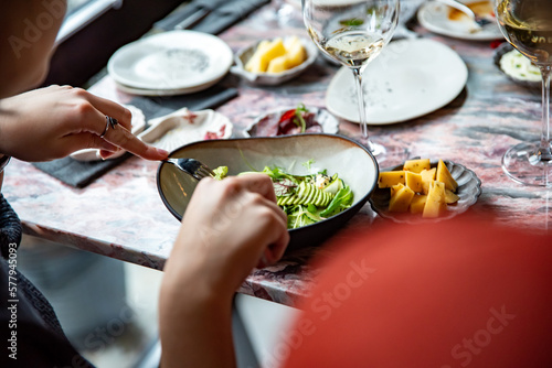 woman hand eating salad in restaurant