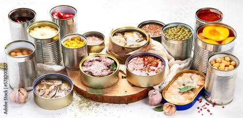 Canned vegetables, beans, fish and fruits in tin cans on a white background. Food stocks.