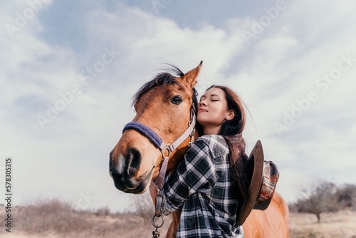 Young happy woman with her horse in evening sunset light. Outdoor photography with fashion model girl. Lifestyle mood. oncept of outdoor riding, sports and recreation.