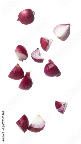 Shallots fall fly in mid air, red fresh vegetable spice shallots onion floating. Organic fresh herbal shallots root head cut chop slice. White background isolated freeze motion high speed shutter