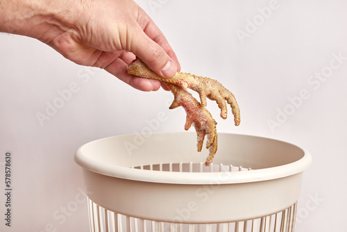 Chicken feet are thrown into the trash.Disposal and recycling of food waste.