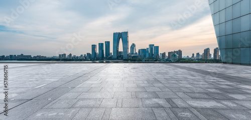 Panoramic view of city skyline and modern buildings with empty floor in Suzhou, China.