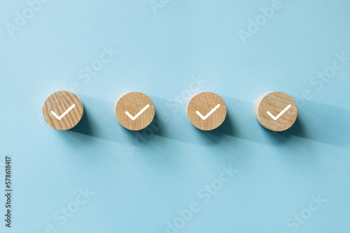 Checklist concept, Check mark on wooden blocks, blue background with copy space