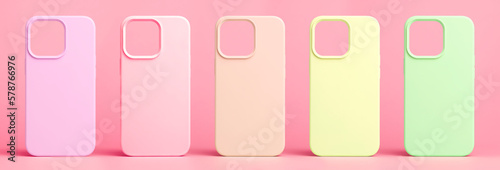 set of five back covers for mobile phone in different colors isolated on pink background, phone case mock up for iPhone 13 Pro Max and 14 Plus