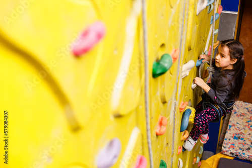 Little Girl Climbing Rock Wall