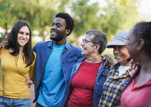 Happy multiracial people having fun outdoor - Multi generational friends at city park