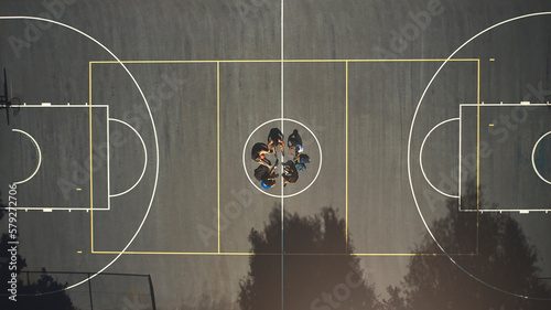 Top view, basketball court or men in training break circle for game strategy, college match planning or target goal collaboration. Basketball players, sports team or community fitness in workout rest