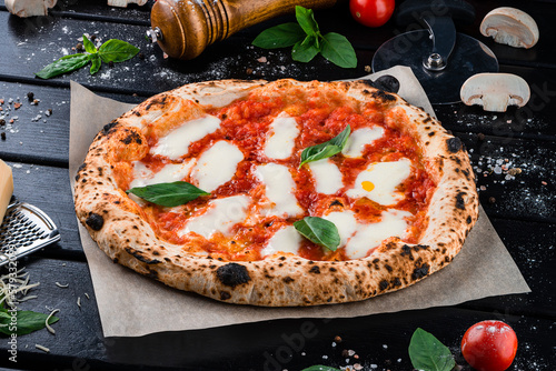 Pizza with mozzarella, tomato sauce, spinach on a thick dough.