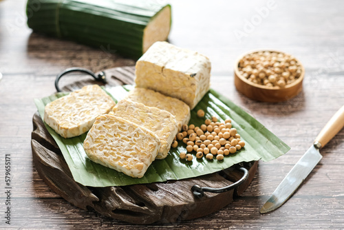 raw tempe or tempeh is a traditional Indonesian food made from fermented soybeans.. Tempeh wrapped in banana leaf.