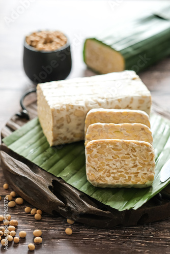 raw tempe or tempeh is a traditional Indonesian food made from fermented soybeans.. Tempeh wrapped in banana leaf.