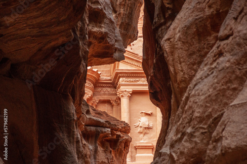 Jordan. Peter. Only road to rock city of Nabatean kingdom, to ancient city of Petra.Canyon Siq or El Siq. Sheer cliffs of a canyon or rocky cleft, 92 to 182 meters high, hang over narrow path.
