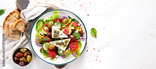 Greek village salad horiatiki with feta cheese, olives, cherry tomato, cucumber and red onion, vegeterian mediterranean food, low calories dieting meal.