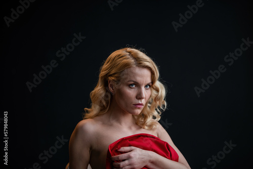 Portrait of candid authentic elegant sexy model blonde girl posing in red pantsuit bare back no bra