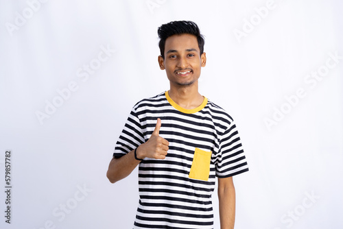 Indian boy Showing thumbsup sign and smiling for brand promotion