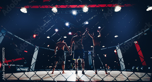 Sport MMA banner, referee raises hand to fighter winner of fights without rules in cage octagon