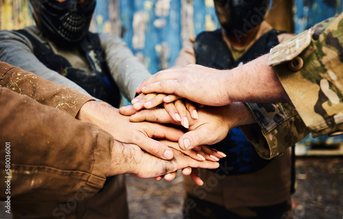 Motivation, team building or hands in huddle on a mission, strategy or soldier training on paintball battlefield. War goals, collaboration or army people with support in partnership or military group