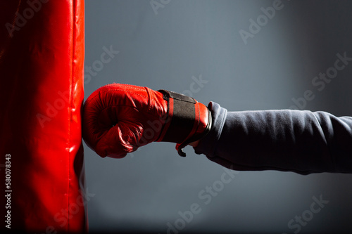 A red glove and a red punching bag