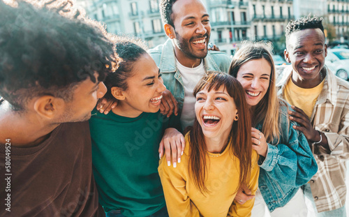 Multicultural young people having fun walking on city street - Happy friends group talking and laughing out loud - University student enjoying time together in college campus - Life style concept