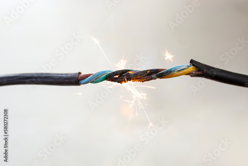 flame smoke and sparks on an electrical cable, fire hazard concept