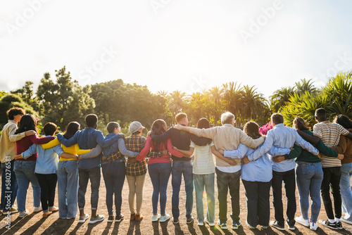 Group of multigenerational people hugging each others - Support, multiracial and diversity concept - Main focus on senior man with white hairs