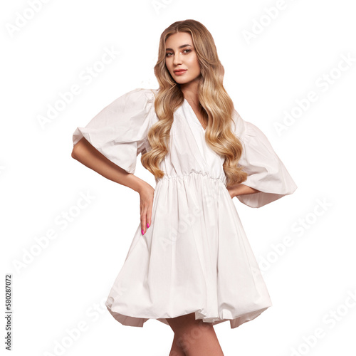 Blonde girl with perfect makeup. Smiling beautiful model woman with long curly hairstyle. Care and beauty hair products. Model in white festive dress