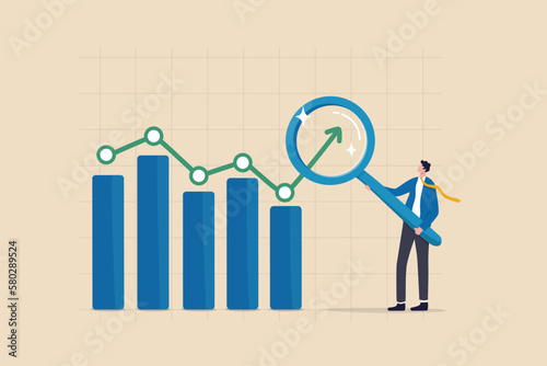 Trend analysis, marketing and sales information, analyze or predict trend line or profit, business forecast report concept, businessman analyst analyze trend graph and chart with magnifying glass.