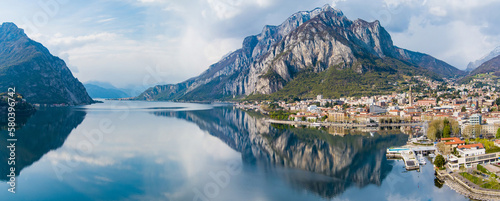 Sunny aerial cityscape of Lecco town on spring day. Picturesque waterfront of Lecco town located between famous Lake Como and scenic Bergamo Alps mountains.