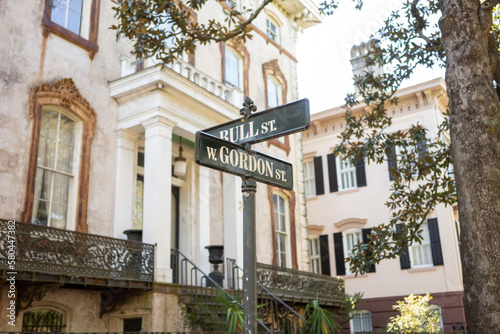 Ornate street sign in Savanah, Georgia, square in front of victorian home on warm summers day