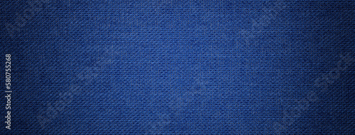 Navy blue background from textile material with wicker pattern, and vignette. Structure of denim fabric