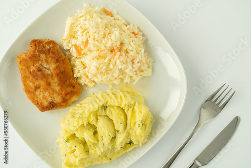 Kotlet schabowy, Polish breaded cutlet, served with mashed potatoes and coleslaw salad. Traditional food in Poland.