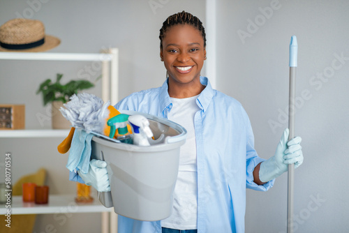 Friendly african american lady maid ready for cleaning house