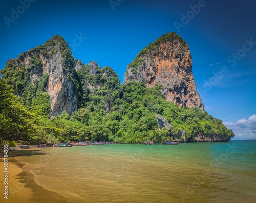 Railay west beach in Krabi district Thailand. Paradise beach with golden sand and green mountains around