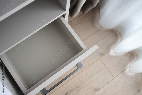 Opened kitchen drawer in room, top view 