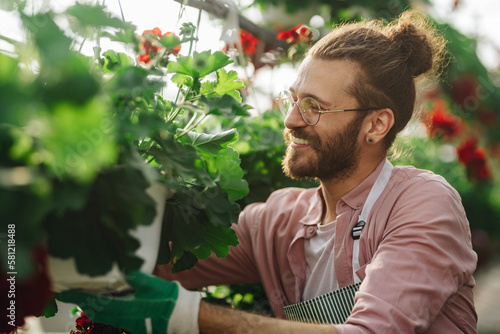 Man gardener working in a greenhouse