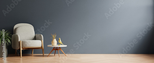 Modern minimalist interior with an armchair on empty dark blue color wall background.