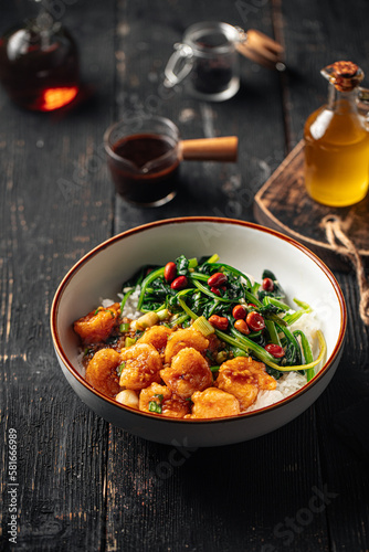 Portion of asian rice dish with shrimp and spinach