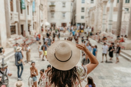 Woman looking out over a square full of people at Diocletian's palace in Split, Croatia