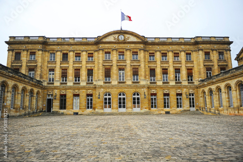 Flag of France waving on Bordeaux City Hall, Rohan Palace, Aquitaine, France