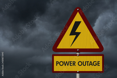 Power Outage message on warning road sign with stormy sky