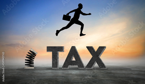 Young Businessman Jumps From Spring Over Tax Text. Concept of Tax Evasion and Avoidance. Sunset Business Scene 