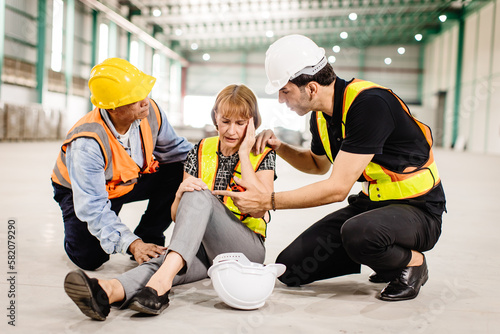 senior female engineer faints sick health problem accident at workplace team staff helping support