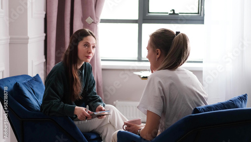 A woman psychotherapist conducts a reception in her office. The patient expresses her feelings in a one-on-one relationship with a specialist. Mental health concept