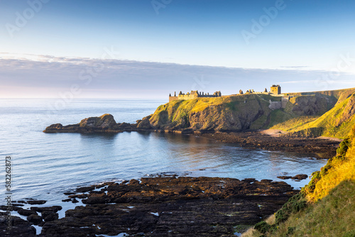Dunnottar Castle bathed in gorgeous morning sun, taken from the cliffs above Castle Haven near Stonehaven in Aberdeenshire.