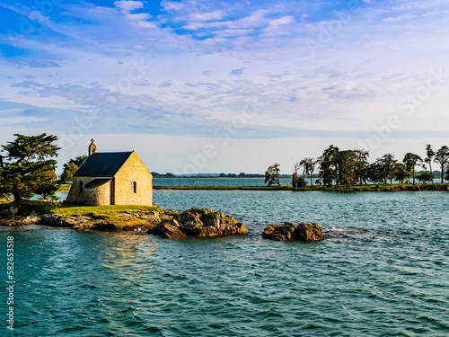 Stunning view of Boedic Island and its famous chapel at sunset, Morbihan Gulf, Brittany, France 