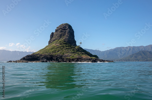 Mokolii island [also known as Chinamans Hat] as seen from the water on the North Shore of Oahu Hawaii United States